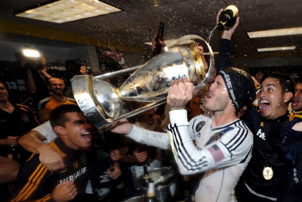 david backham of los angles glaxy drink out of the mls trophy
